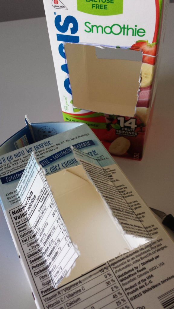 milk carton,juice carton,bird feeder,window